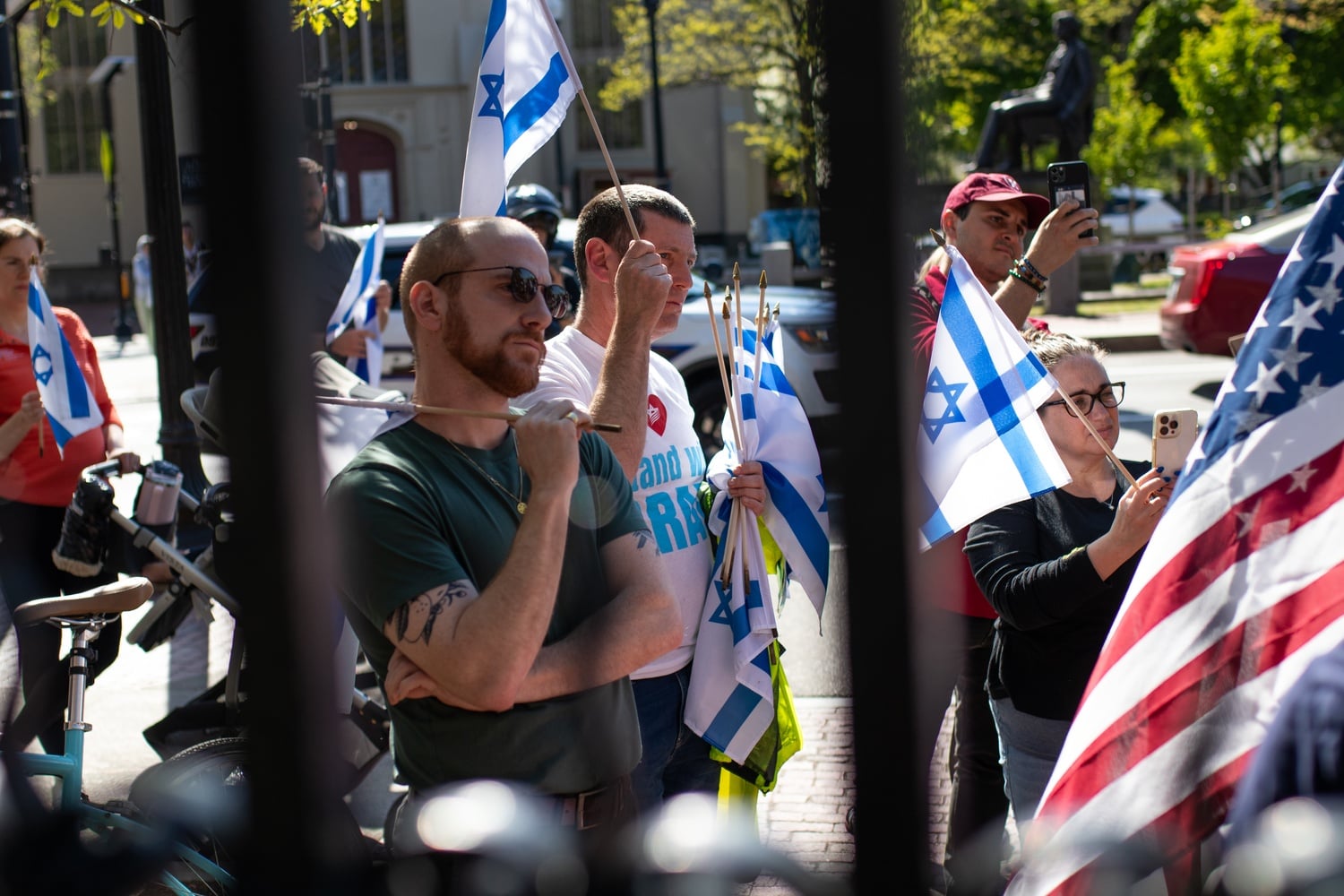 Pro-Israel counterprotesters held Israeli flags and a large American flag during a Monday rally at Johnston Gate.