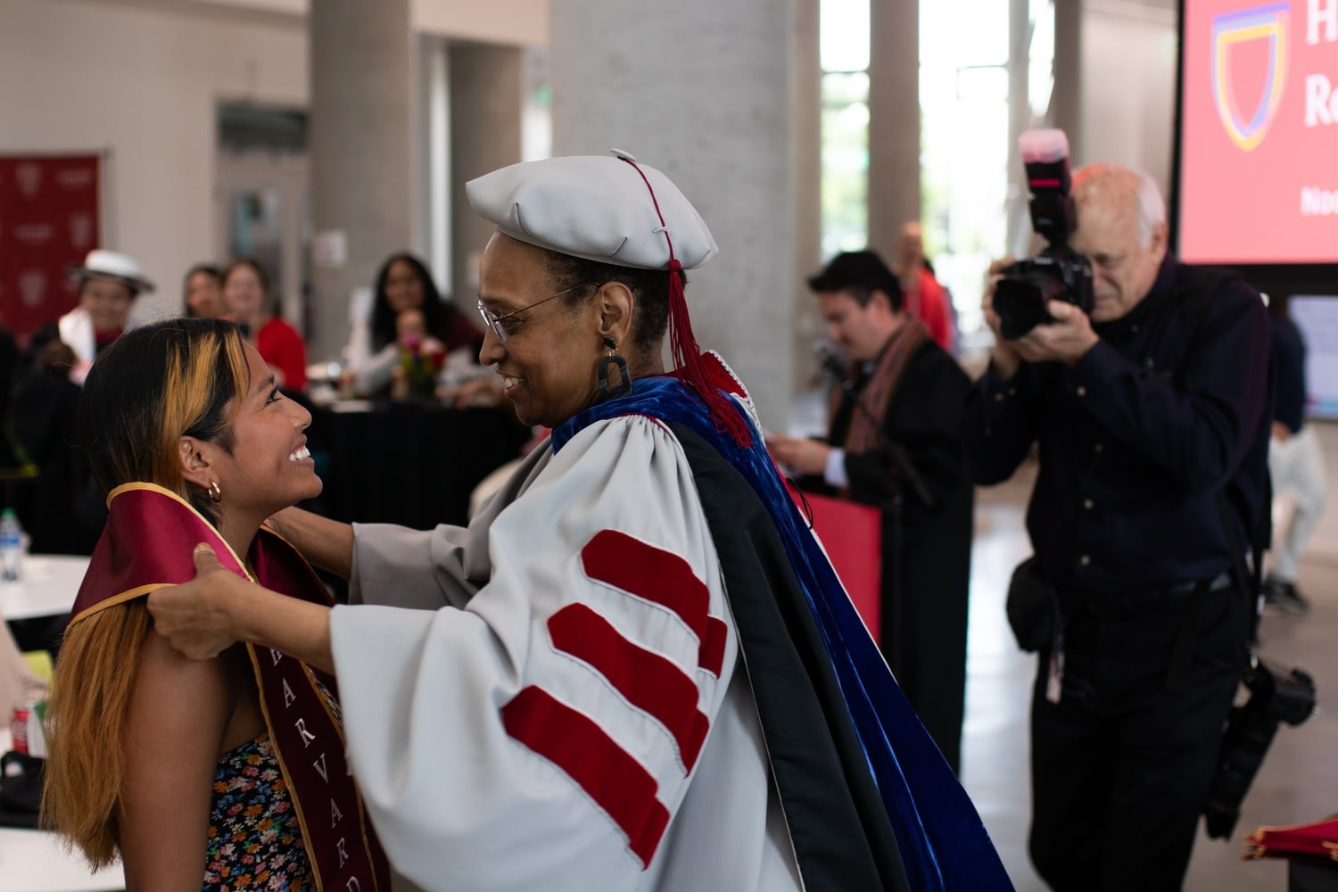 A student receives a stole at a ceremony for Indigenous students graduating from Harvard last year. This year, the Harvard University Native American Program will not host an Indigenous Graduation Ceremony, but students will still receive traditional blankets.