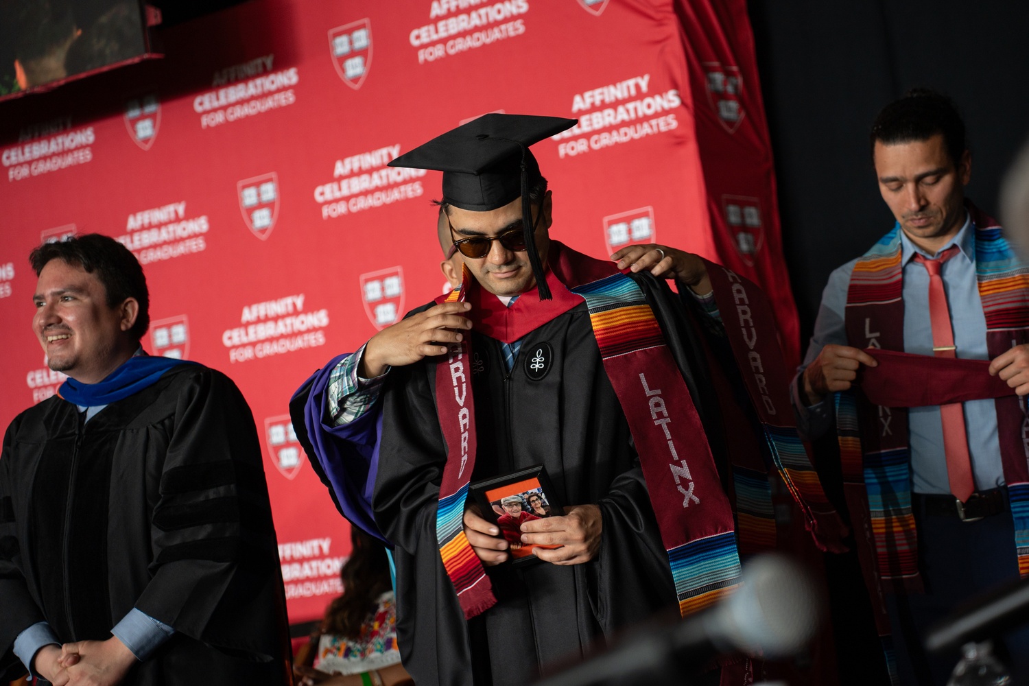 A student receives their stole at the Latinx affinity graduation.