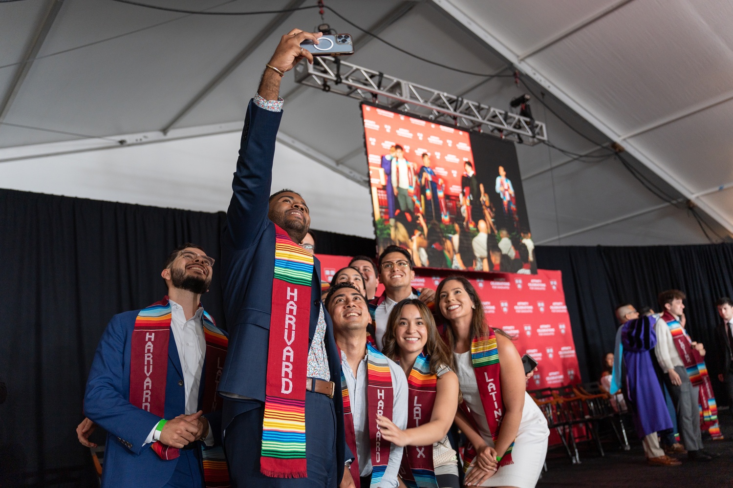 Students pose for a selfie after receiving their stoles at Harvard's 2024 affinity celebration for Latinx students.