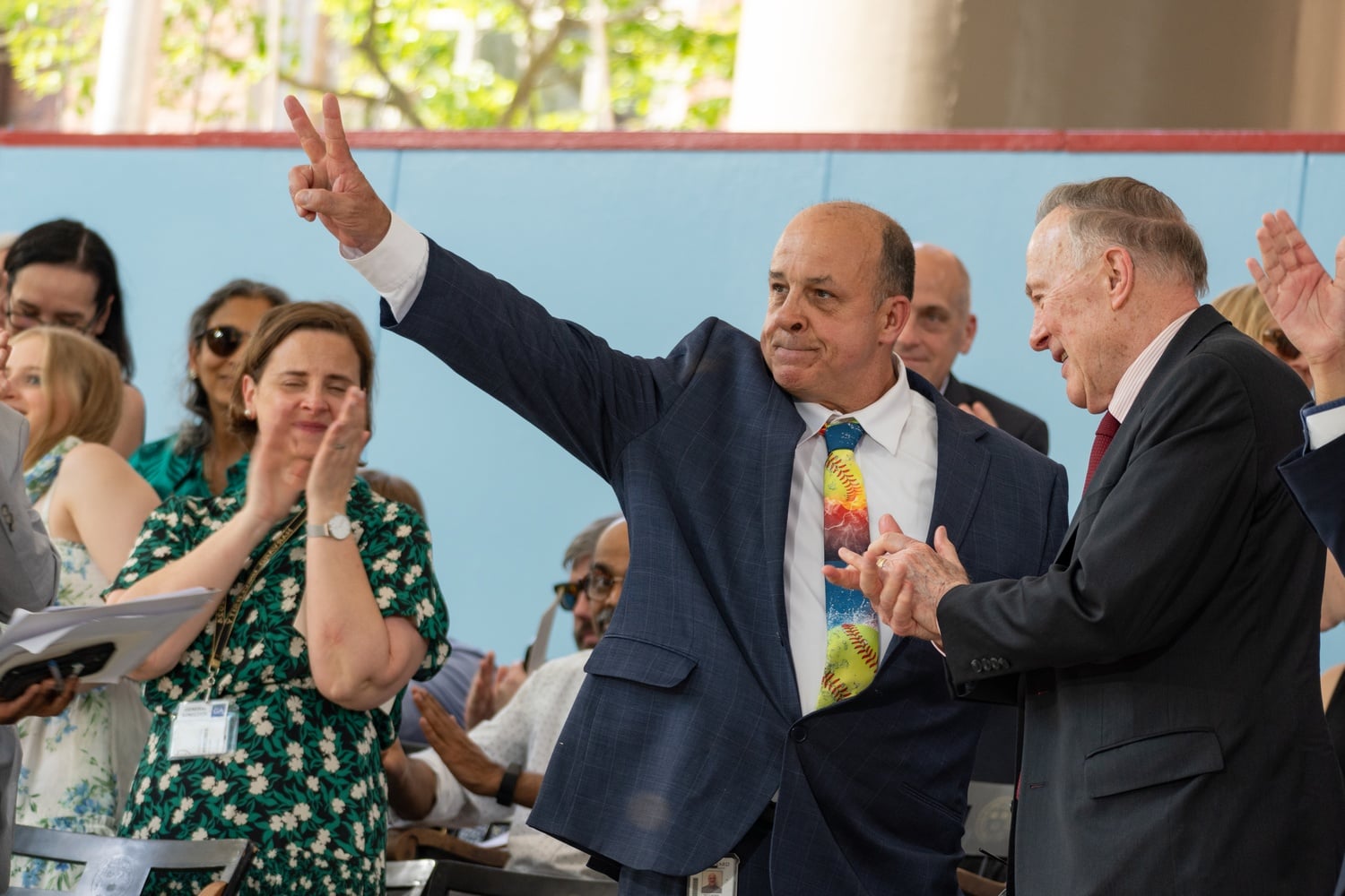 Beloved Currier House employee Bill Oliverio waves to the crowd at Harvard College's Class Day. Oliverio, alongside Dean of Admissions and Financial Aid William R. Fitzsimmons '67, gave the keynote address at the annual undergraduate graduation ceremony.