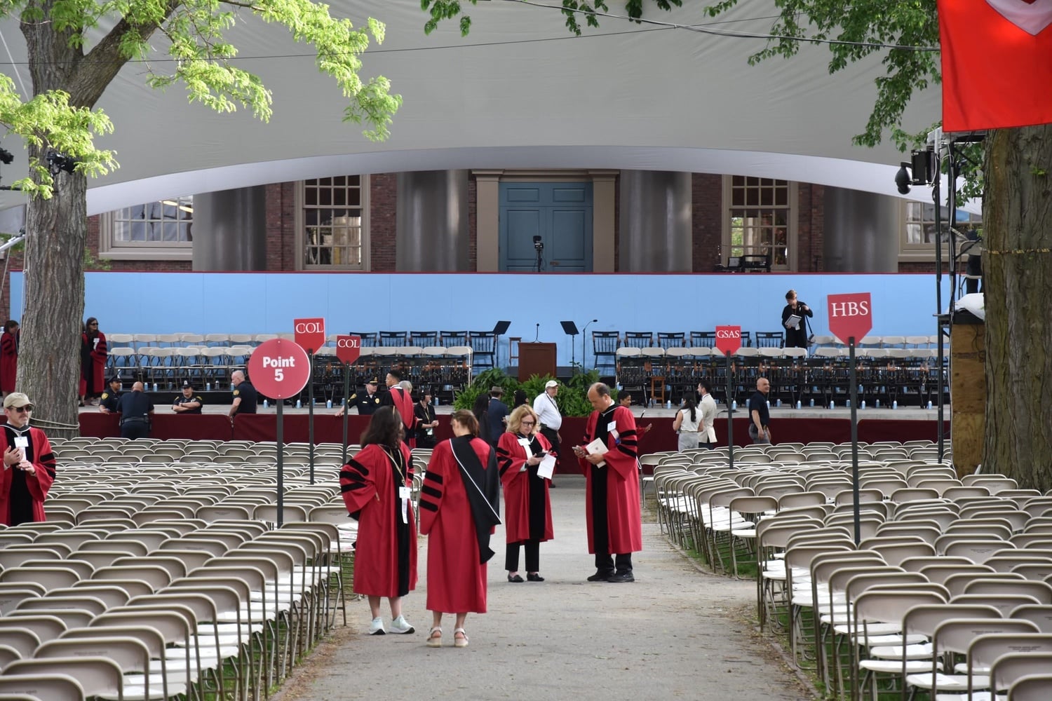University officials in regalia prepare for the ceremonies in front of Memorial Church.