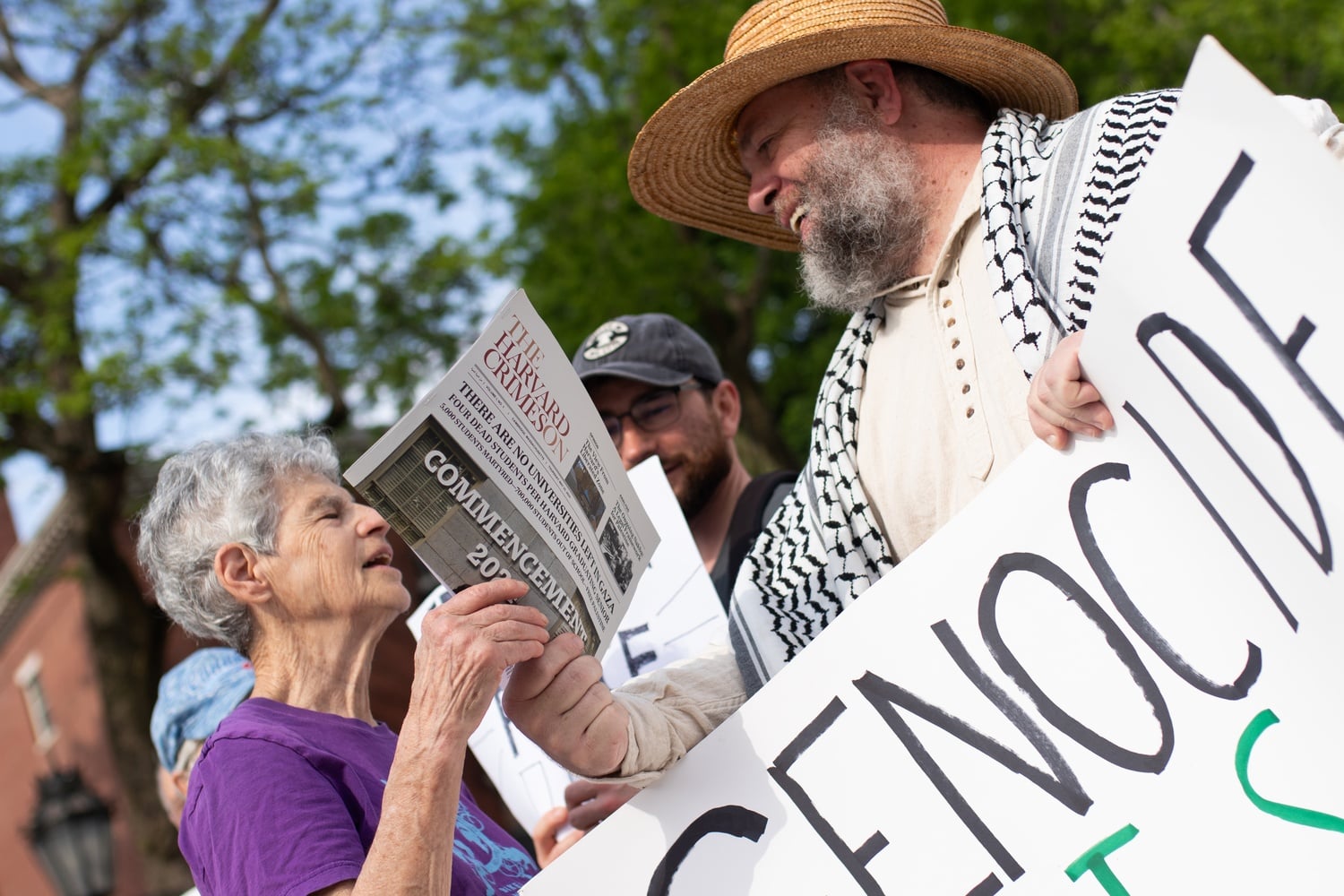 Pro-Palestine protesters laugh as they distribute fake issues of The Harvard Crimson, titled The Harvard Crimeson, Thursday morning.