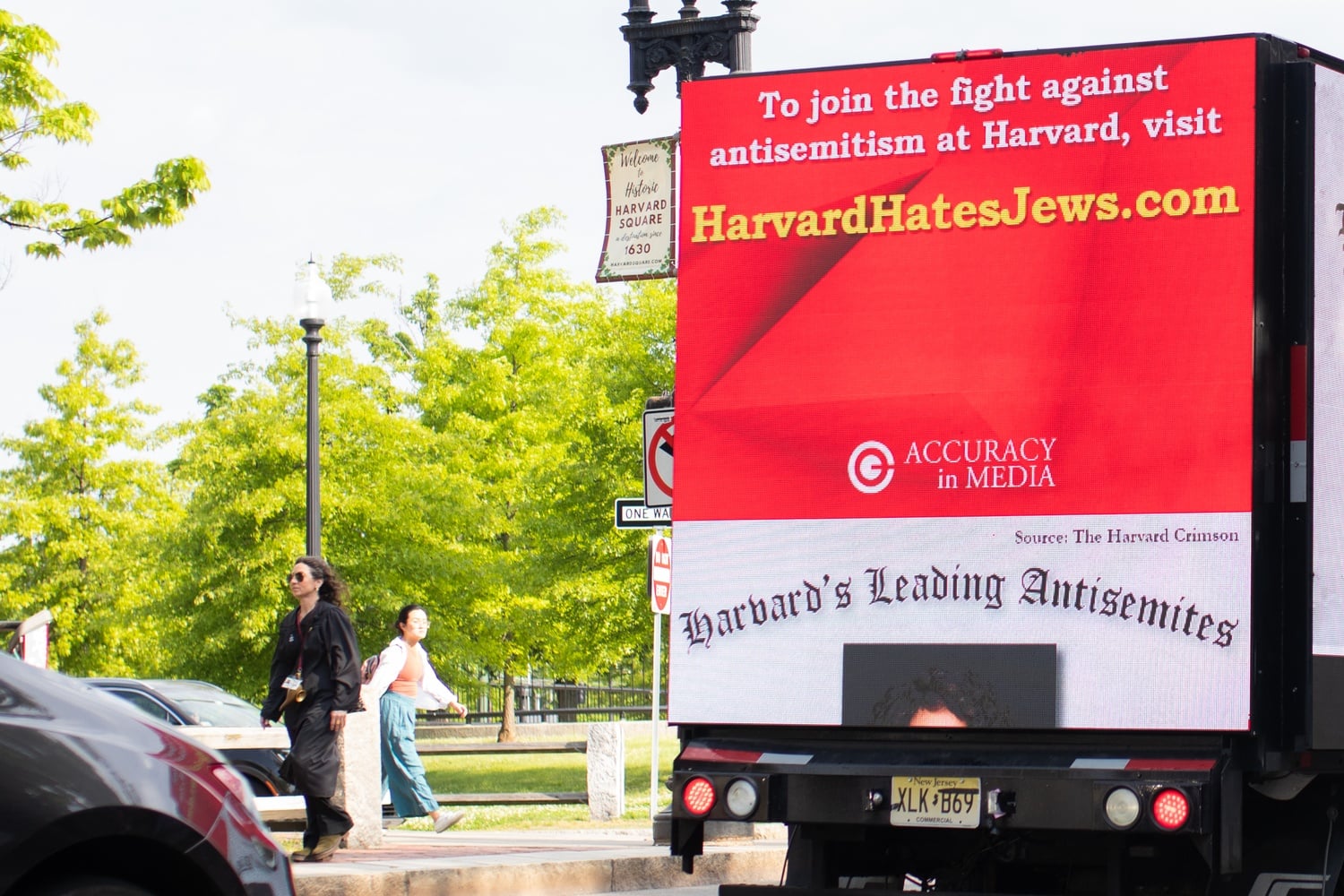 A doxxing truck circles Harvard Yard on Commencement morning. Police officers outside Harvard Yard warned the truck drivers that the truck cannot park outside Johnston Gate.