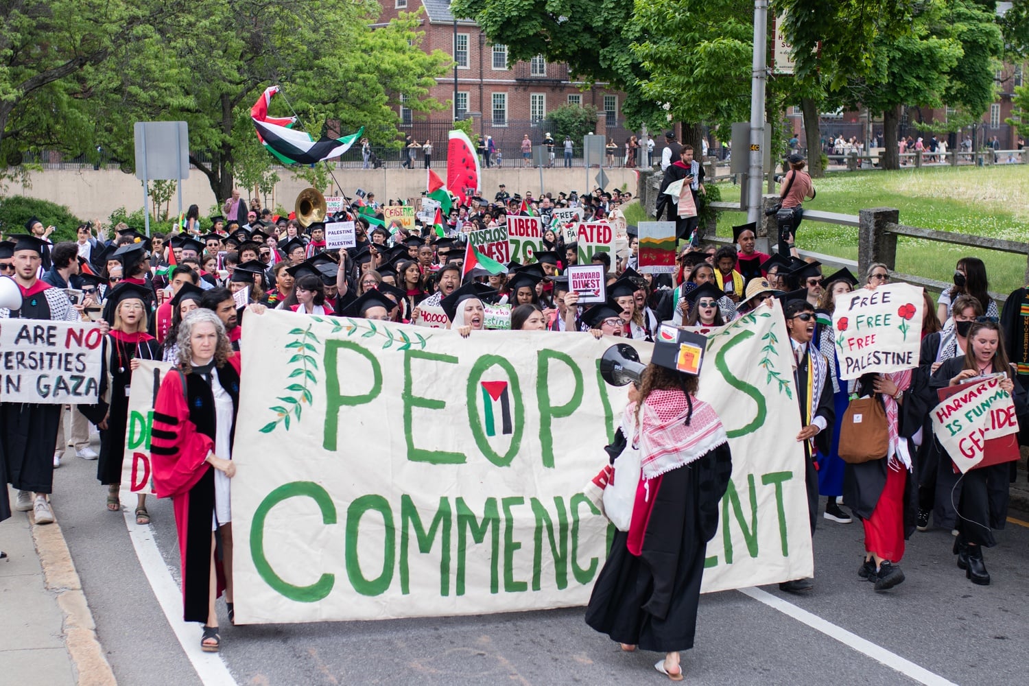 Harvard graduates, faculty, and family members marched through Cambridge Thursday after walking out of Harvard's 2024 Commencement exercises.