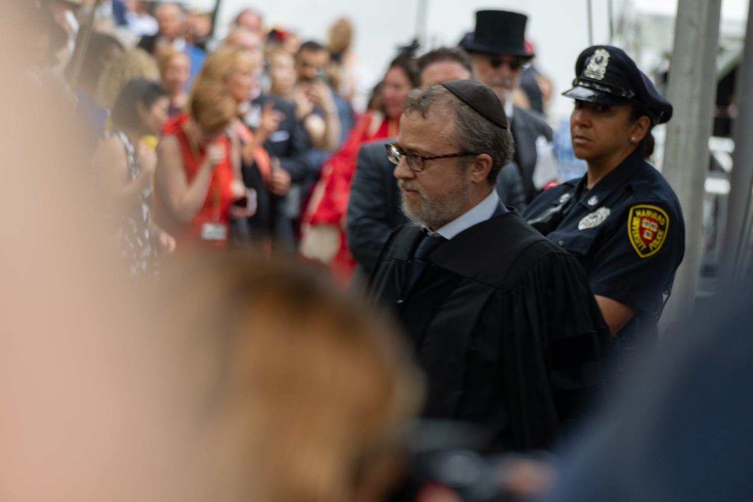 Harvard Chabad Rabbi Hirschy Zarchi walks off the stage during the Commencement ceremony Thursday. Zarchi confronted Nobel laureate and journalist Maria A. Ressa after taking issue with her speech.