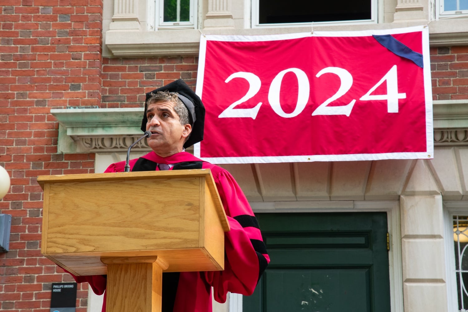 Harvard College Dean Rakesh Khurana speaks outside PBHA on Commencement morning.