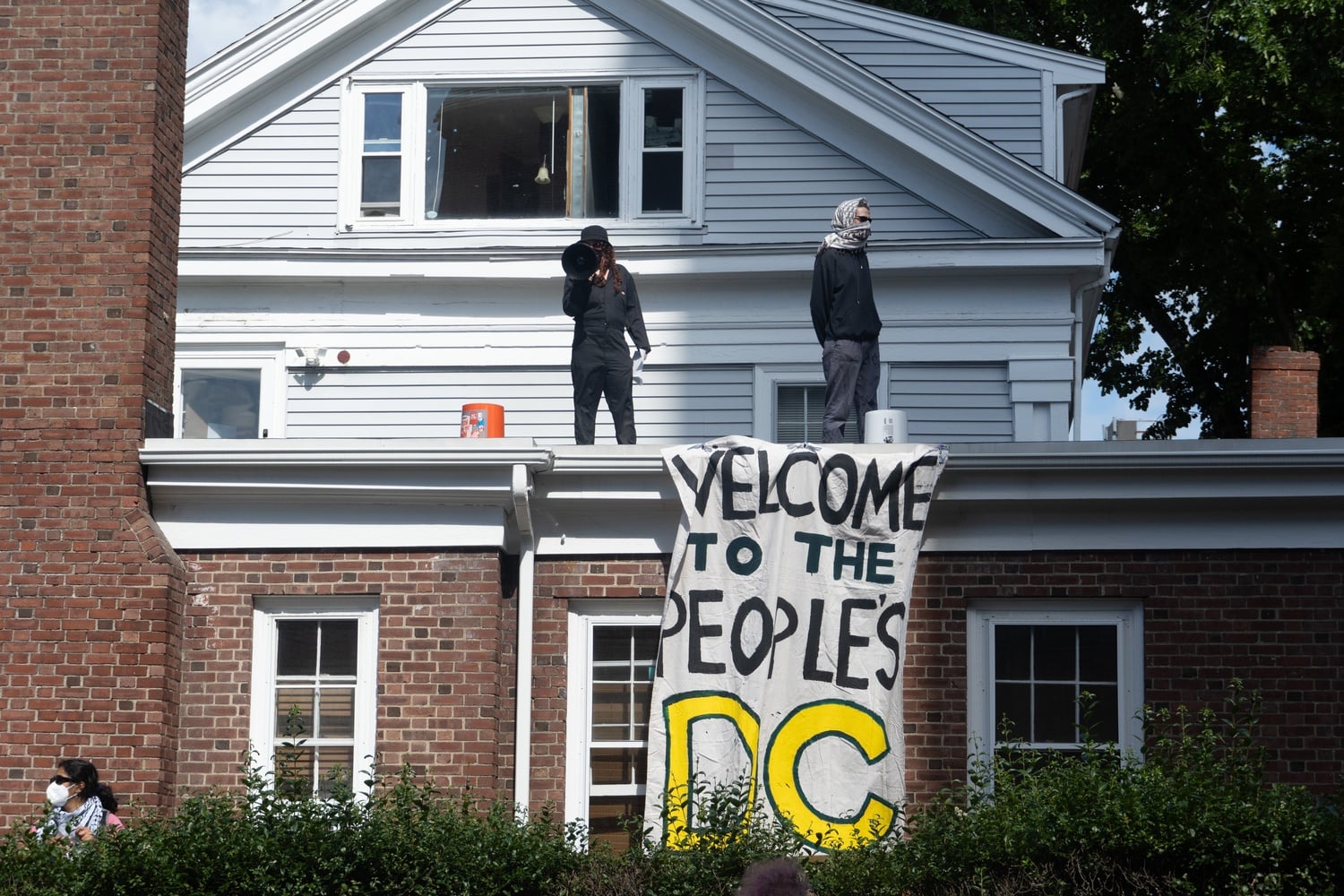 Organizers led chants from the roof of the building and hung a banner that read, "Welcome to the People's DC."