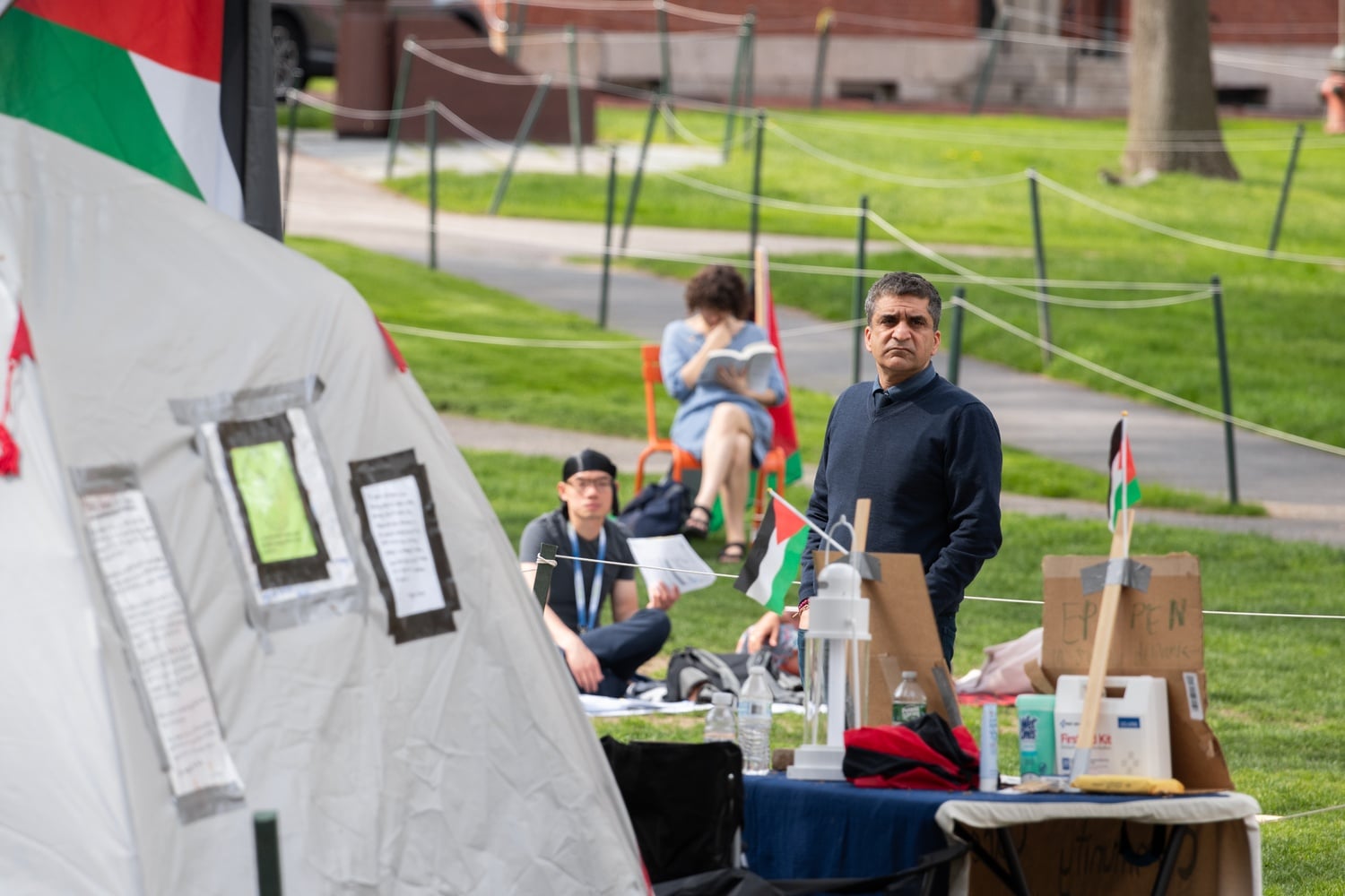 Harvard College Dean Rakesh Khurana watches the pro-Palestine encampment on May 6. Top University officials privately criticized the schools' disciplinary committees for not imposing harsher penalties on student protesters.