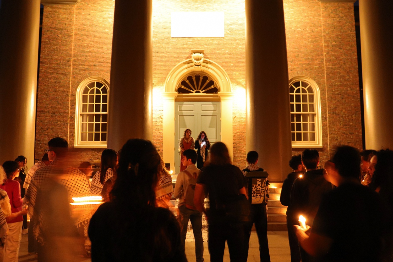 More than 70 students and affiliates gathered on the steps of Memorial Church for the candlelit vigil on Thursday.