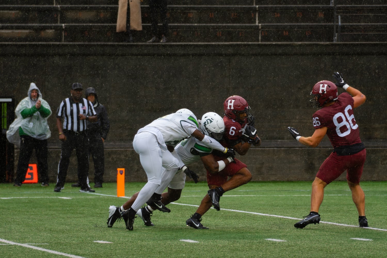 Senior wide receiver Scott Woods II gets tackled by a Stetson player during Harvard’s home opener on Saturday.