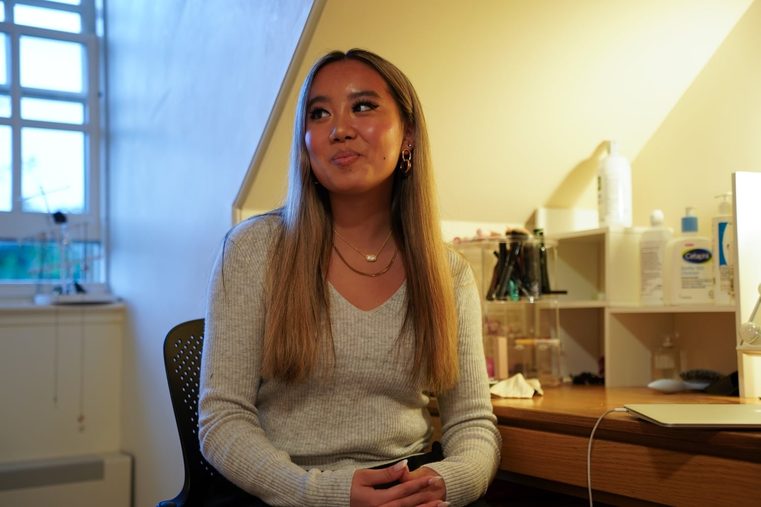 Olivia Zhang ’27 poses for a portrait in her room.