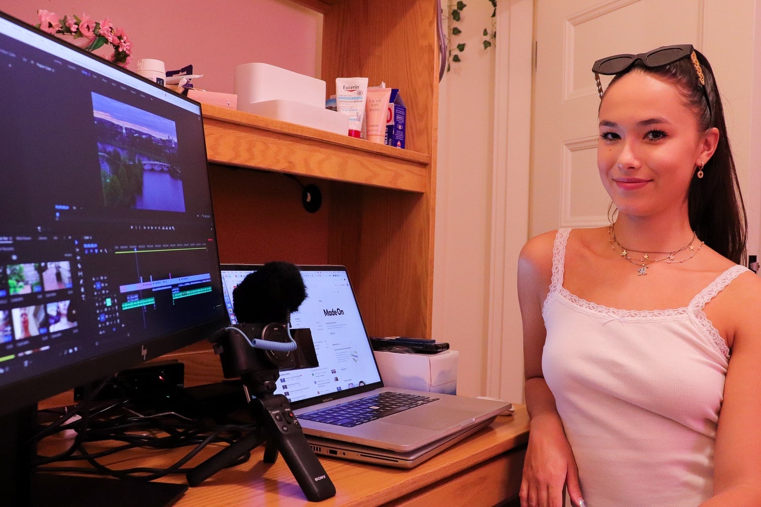 Helen L. Piltner ’25 poses for a portrait at her desk, where she edits her videos.