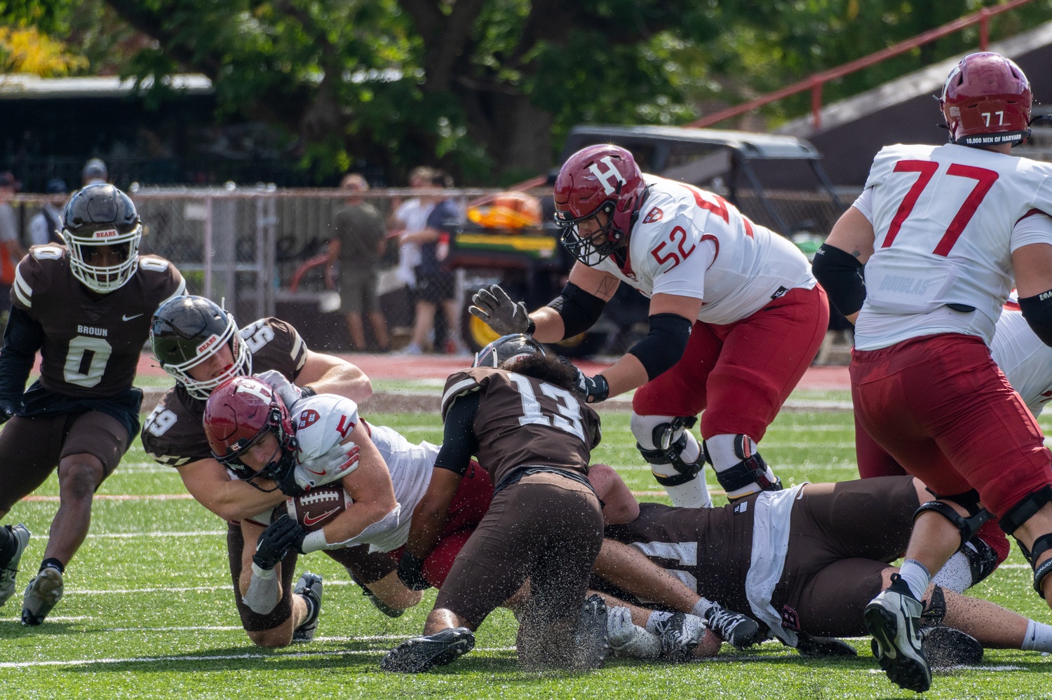Brown sophomore linebacker Stefano Montella tackles Harvard senior running back Shane McLaughlin during the Ivy League season opener for both teams on Saturday. Brown mounted a remarkable comeback in the second half to defeat Harvard for the first time in more than a decade.