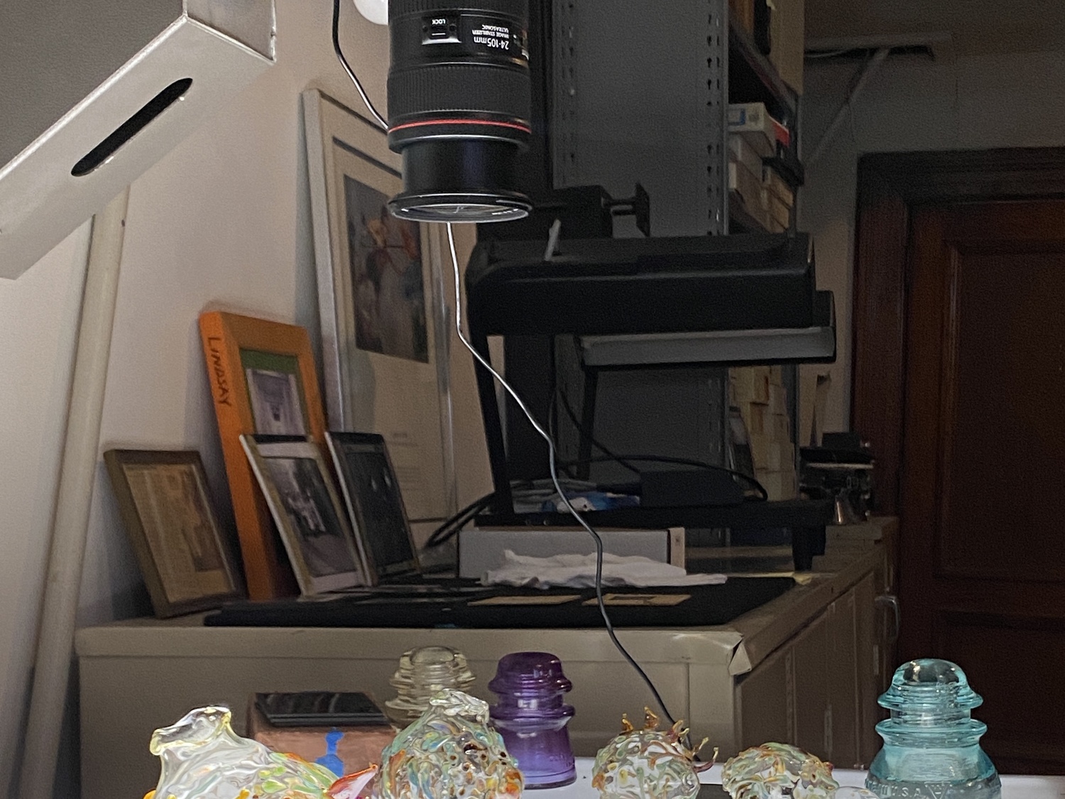 Process view of photographing lantern slides with glass objects.
