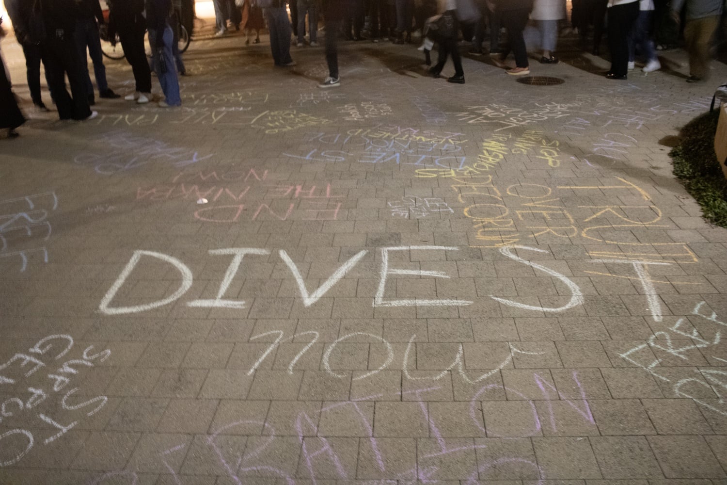 Protesters wrote chalk slogans on the ground reading 'Divest,' 'End the Nakba Now!' and 'Truth over decorum,' among others.