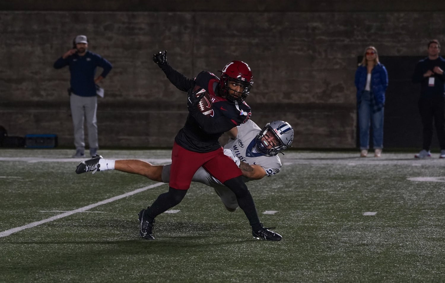 Senior wide receiver Scott Woods II avoids a New Hampshire defender to score the Crimson’s first touchdown on Friday.