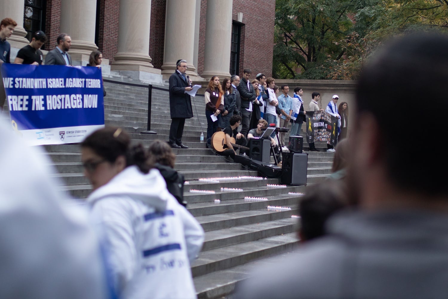 An attendee speaks on the Widener Steps during the Harvard Hillel and Chabad-hosted vigil.