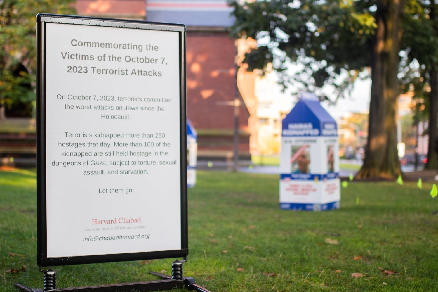 A sign commemorates the one-year anniversary of the October 7th terrorist attacks.