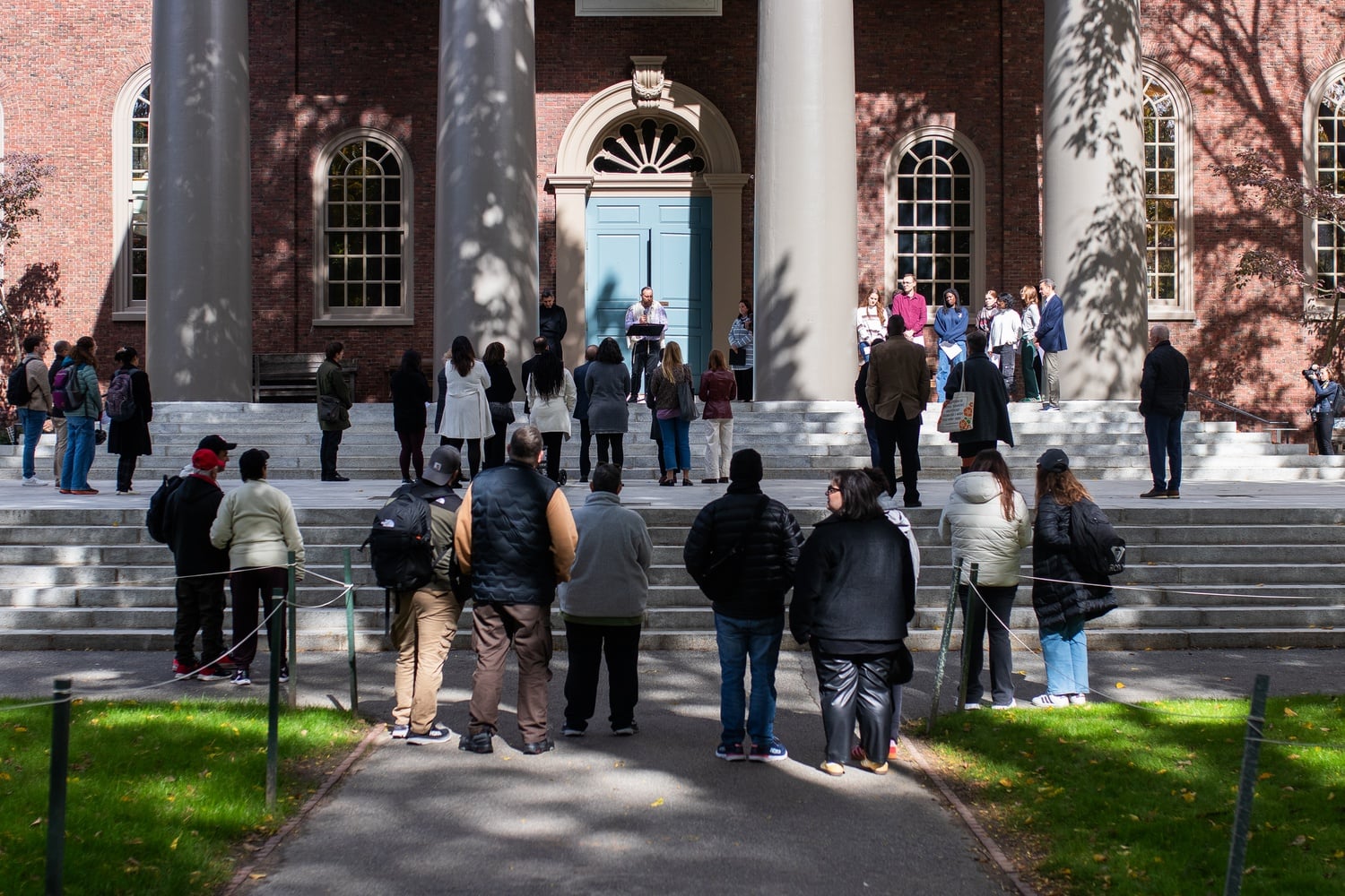 More than two dozen attendees gathered on the steps of Memorial Church Tuesday afternoon, including Harvard President Alan M. Garber '76 and Harvard College Dean Rakesh Khurana, for an interfaith vigil.