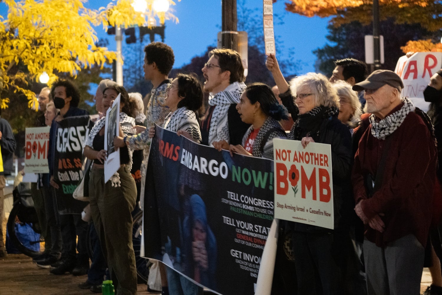 Harvard affiliates and Cambridge residents protest outside of First Parish Church Wednesday night.
