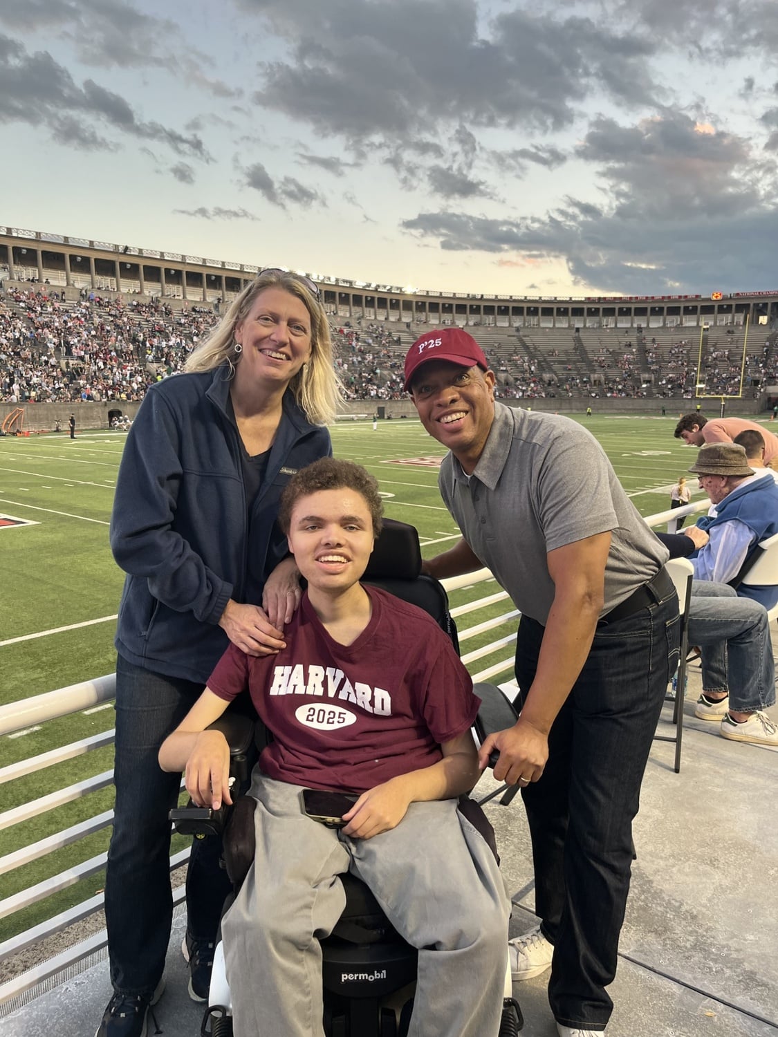 Murdock poses with his parents at the stadium during Family Weekend 2023.