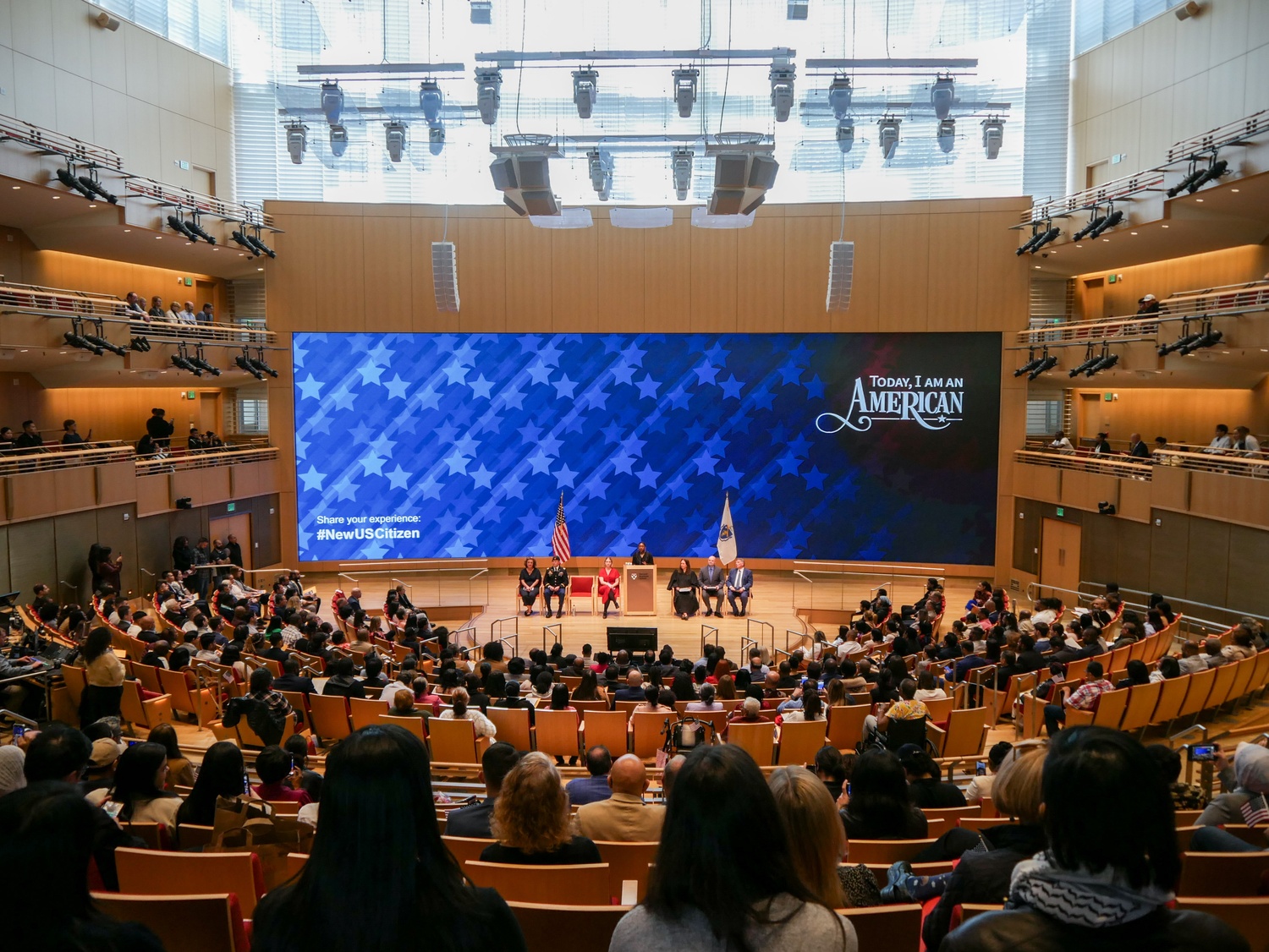 The audience listens to a panel discussion during the Harvard Business Schools's naturalization ceremony in Klarman Hall.