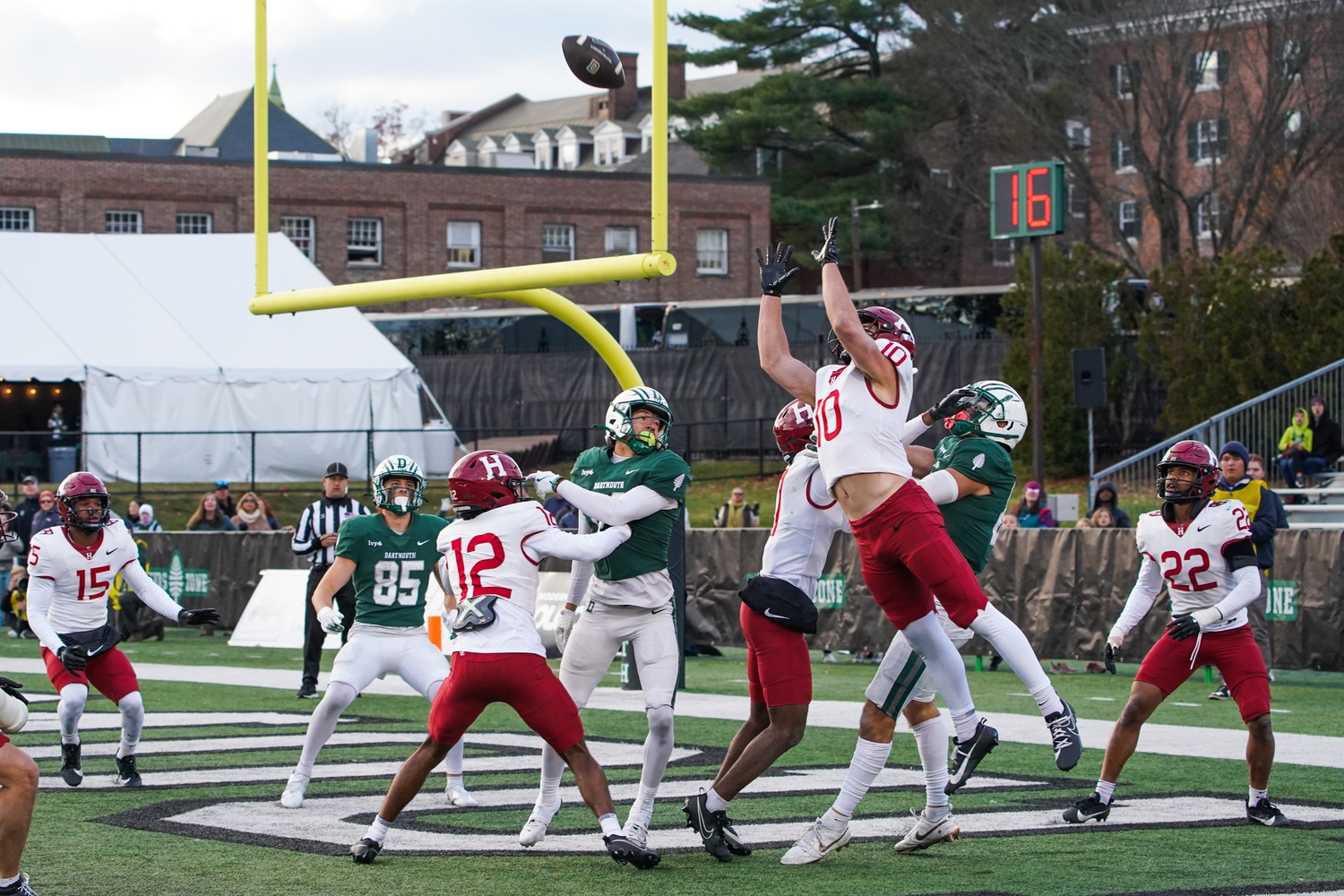 The Crimson’s defense stops a would-be Hail Mary touchdown pass from Dartmouth during a game in Hanover on Saturday.