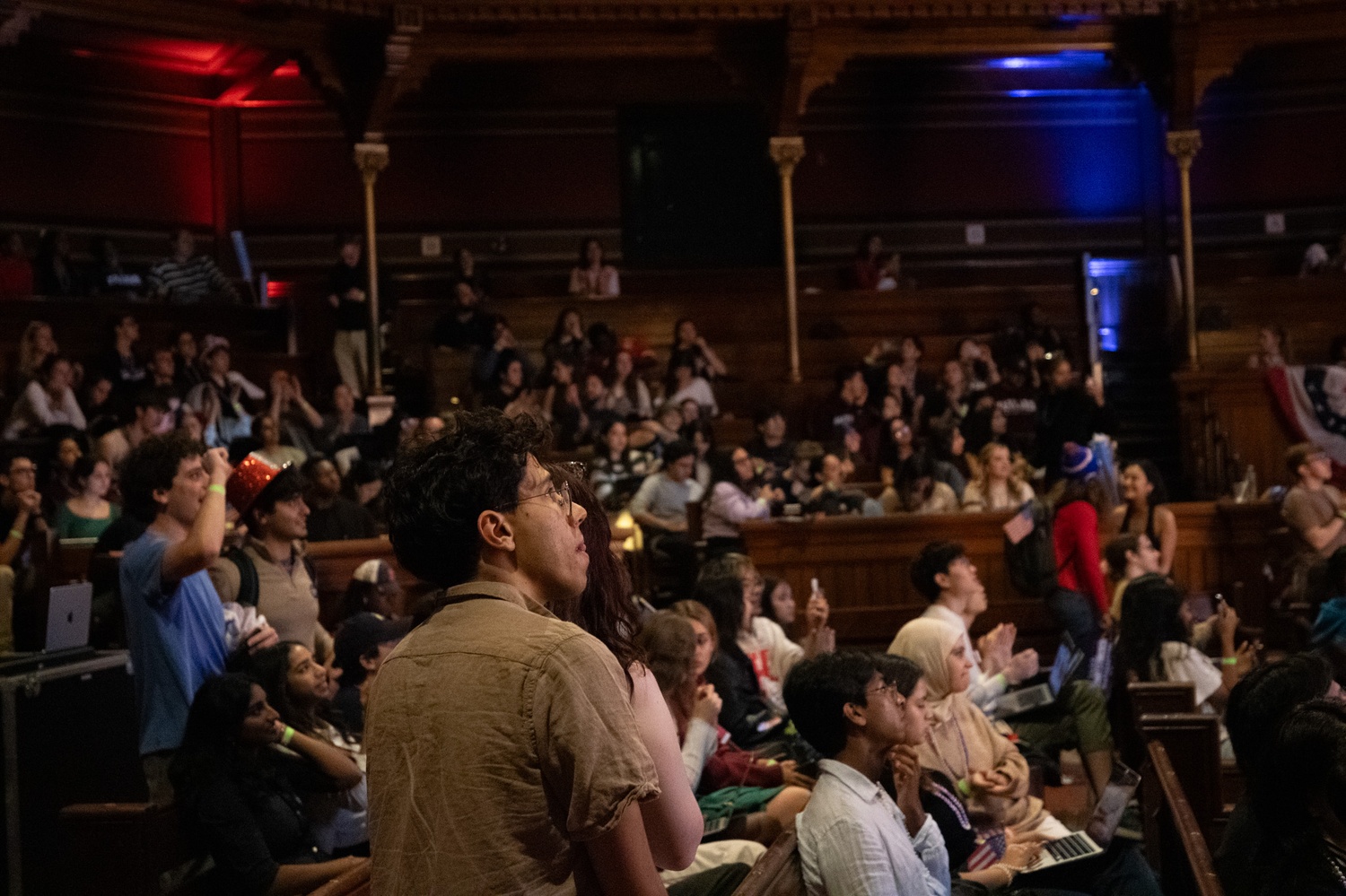 Harvard students watch the November 2024 election returns in Sanders Theatre. When Donald Trump was sworn in, undergraduates watched with anger, fear, and hope.