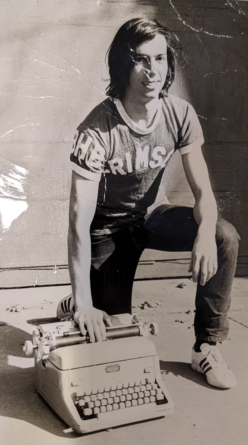 Bennett Ben H. Beach '71 posing with his typewriter at The Crimson's headquarters at 14 Plympton Street.