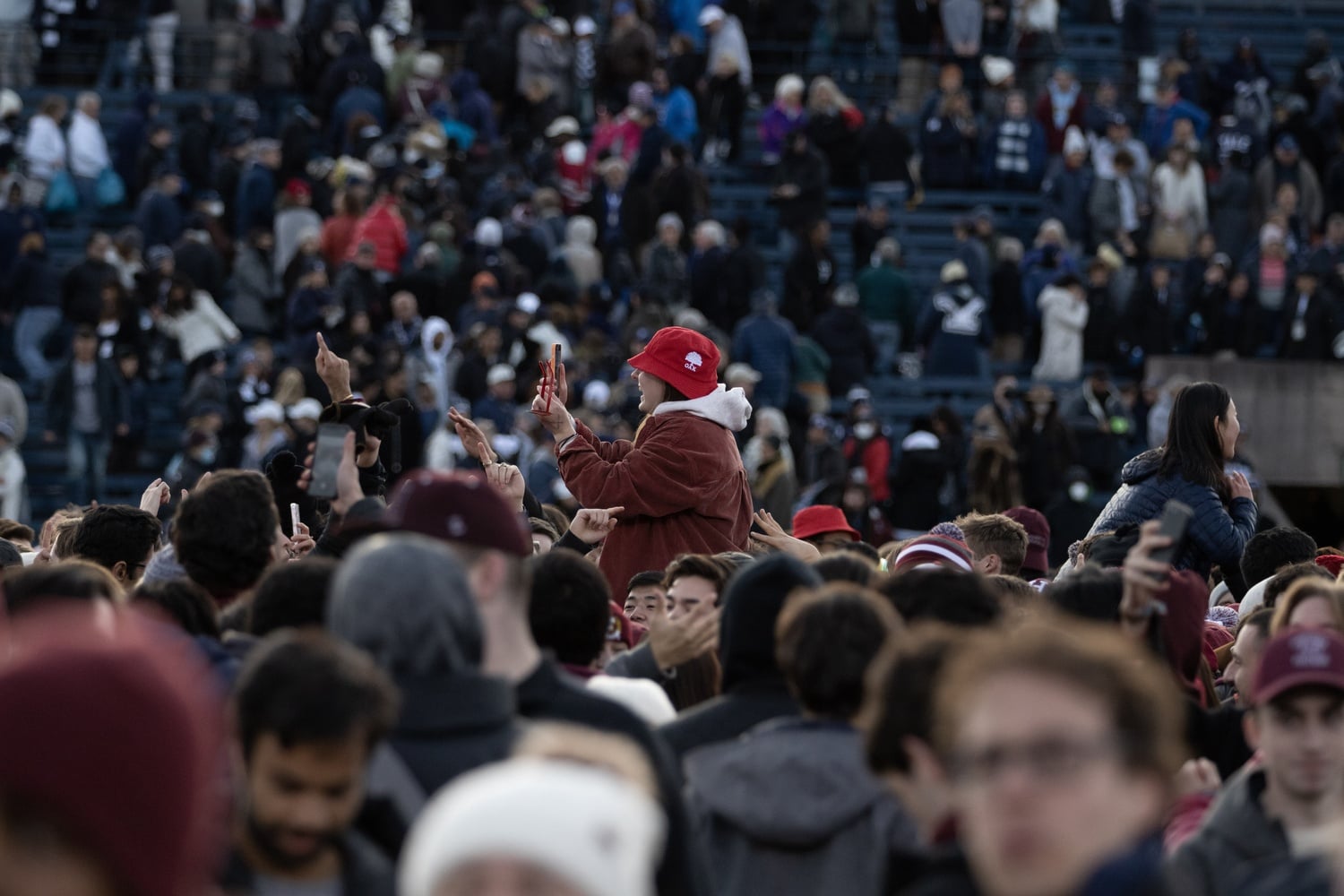 Crimson fans storm the field at the Yale Bowl in 2021.
