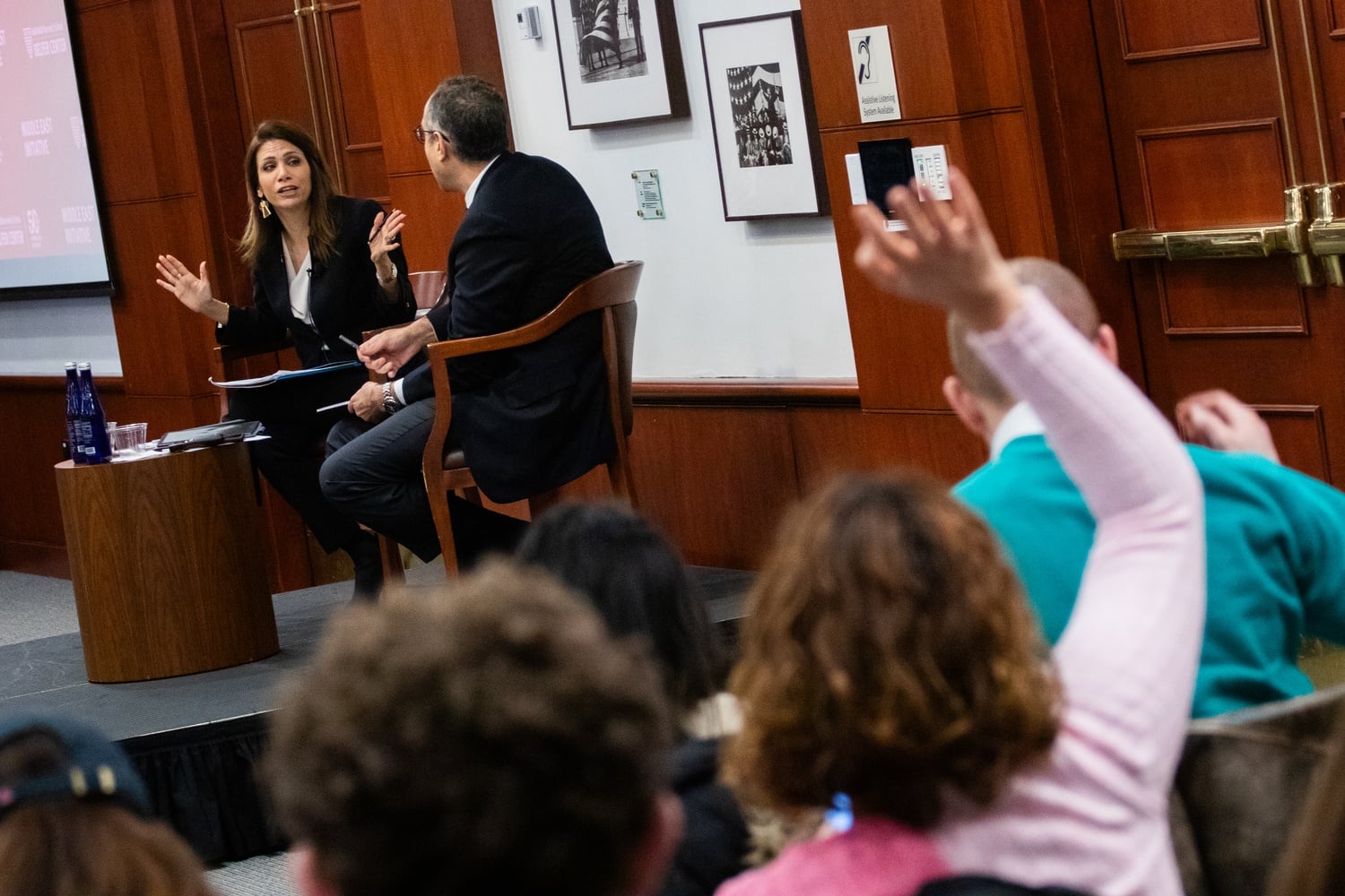An attendee raises their hand as Dr. Dalal Saeb Iriqat speaks at Masoud's Middle East Dialogues event.