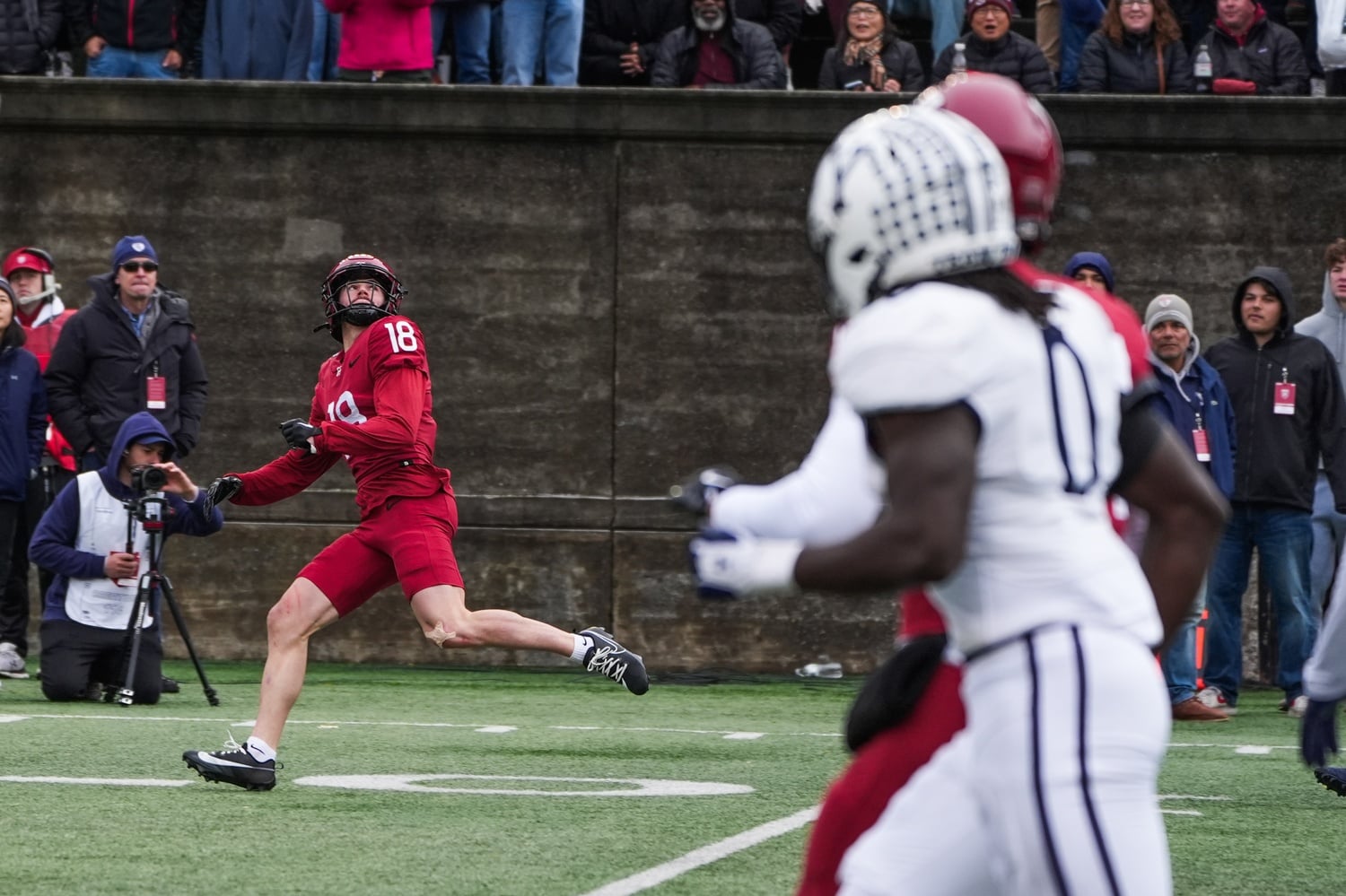 Junior wide receiver Cooper Barkate keeps his eye on the ball moments before he catches the Crimson's first touchdown of the game.