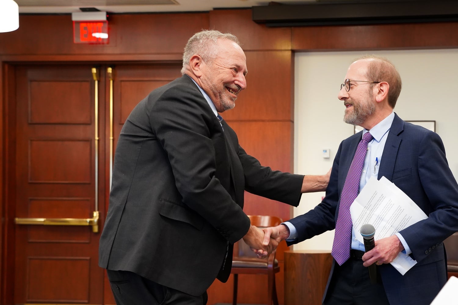 Former University President Lawrence H. Summers greets Harvard President Alan M. Garber '76 at his 70th birthday symposium in November. On Tuesday, Summers took to X to accuse Garber's administration of slow-walking its response to antisemitism.