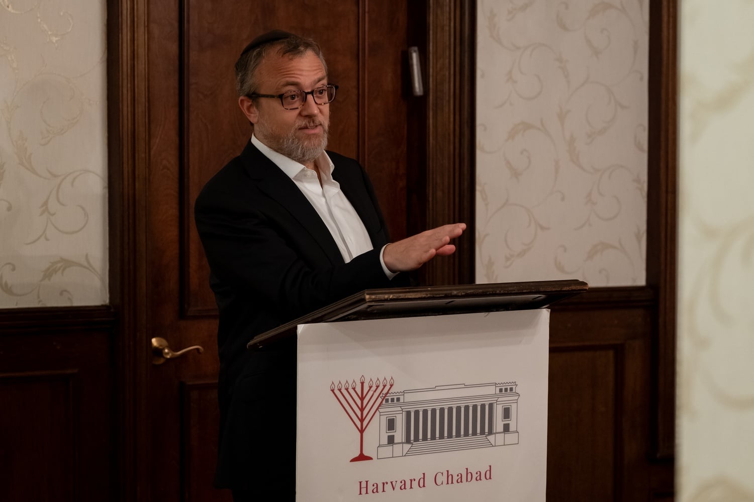 Harvard Chabad Rabbi Hirschy Zarchi speaks at a Chabad vigil in November 2024. Zarchi spent months discussing possible zoning changes with Cambridge officials as the organization sought approval for its Banks Street expansion.