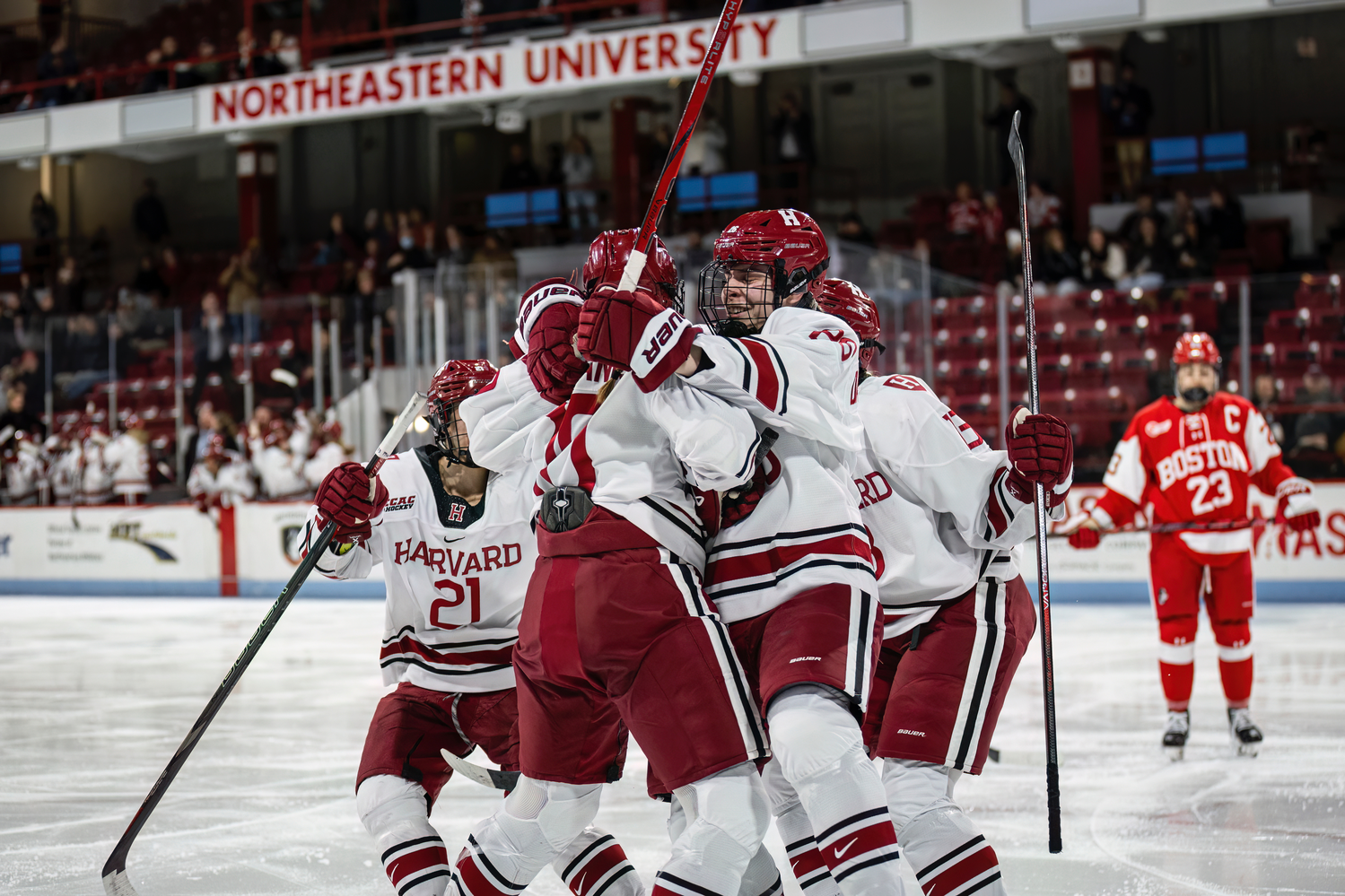 Harvard women's hockey celebrates in a Beanpot game against Boston University last season.