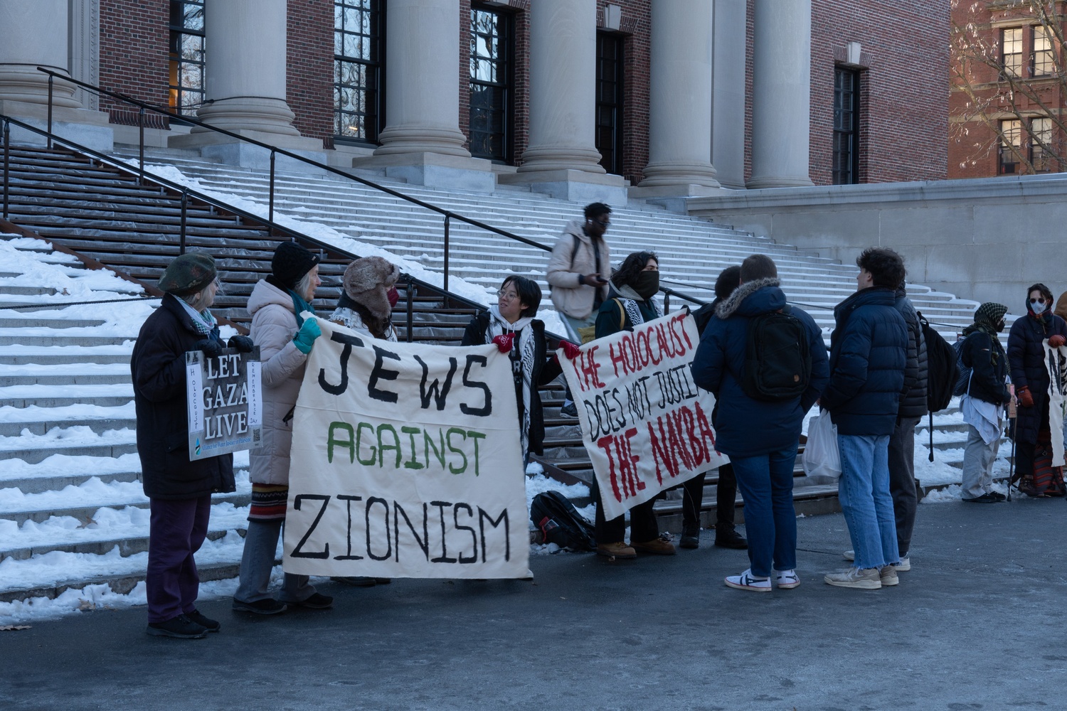 Harvard Jews for Palestine organized a rally outside Widener Library on Monday to commemorate International Holocaust Remembrance Day and to protest Harvard's settlement of two antisemitism lawsuits. Participants held signs in front of the building's steps.