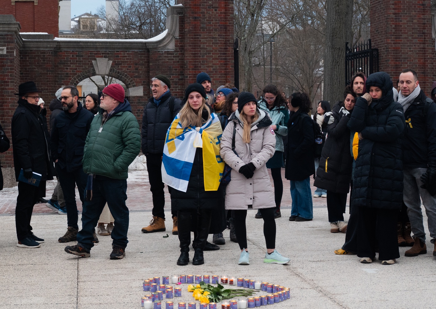 Vigil attendees gather outside the Science Center on Thursday. The event was organized to honor four people who died after being taken hostage by Hamas.