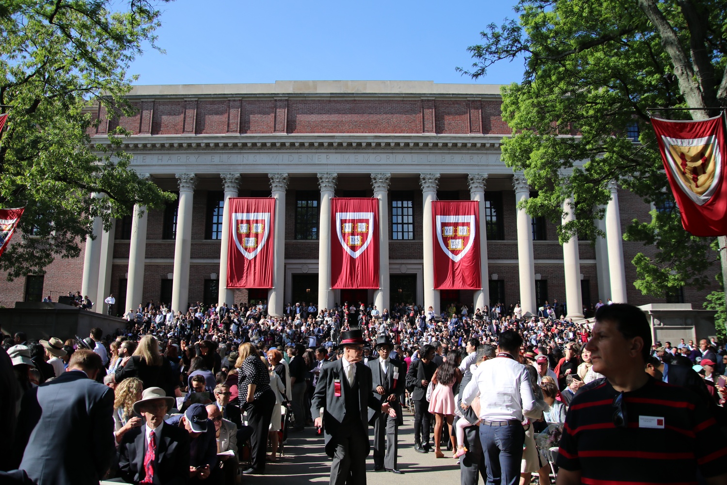 Students and families gather in front of Widener Library in anticipation of the 2024 Commencement exercises in May.