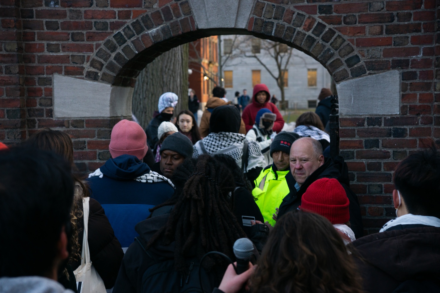 A guard checks student IDs outside of the Science Center gate of Harvard Yard. The Yard remained closed for several hours after the pro-Palestine protest.