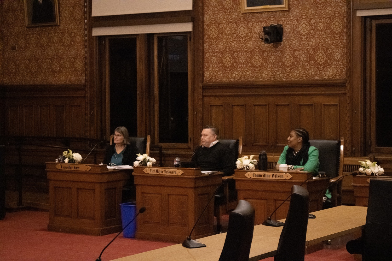 Cambridge Vice Mayor Marc C. McGovern and City Councilors Catherine “Cathie” Zusy and Ayesha M. Wilson sit in Sullivan Chamber for a City Council meeting Monday.