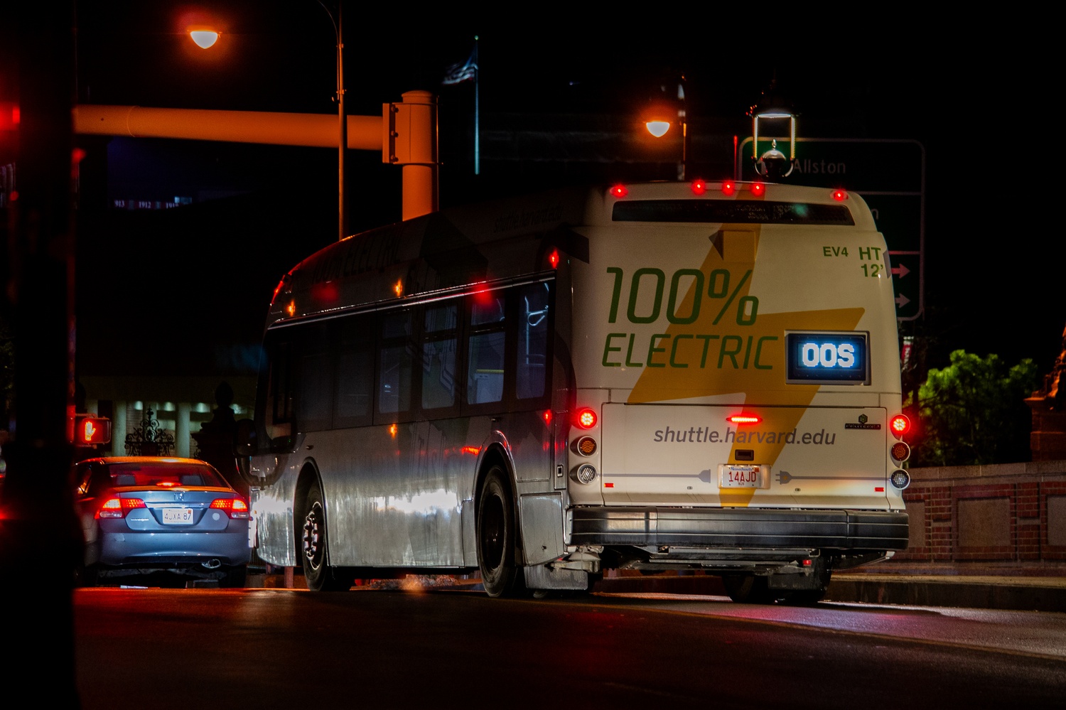 A Harvard shuttle drives over the John F. Kennedy Memorial Bridge at night. Harvard Transportation Services is assessing options for an alternative shuttle tracking service amid criticisms from students who say its current tracker is unreliable.