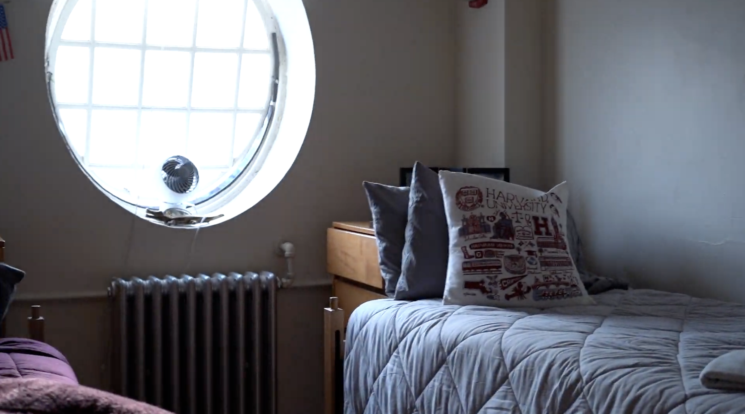 A dorm room in Eliot House, complete with a beautiful circular window.