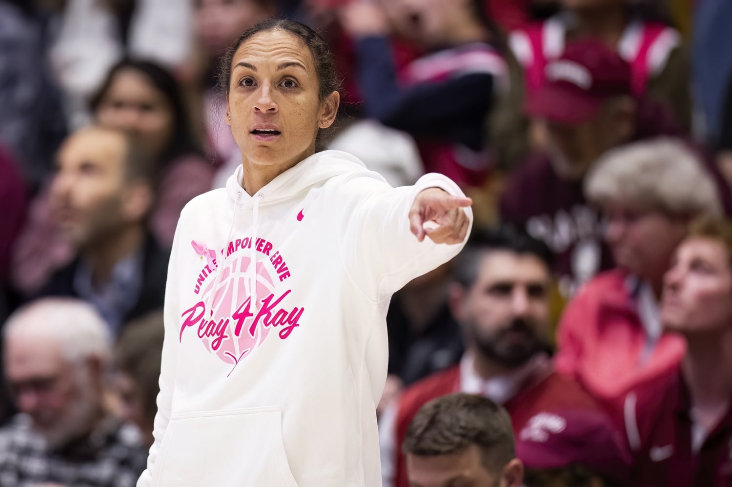 Head Coach Carrie Moore signals a play for the team in its game against Princeton 