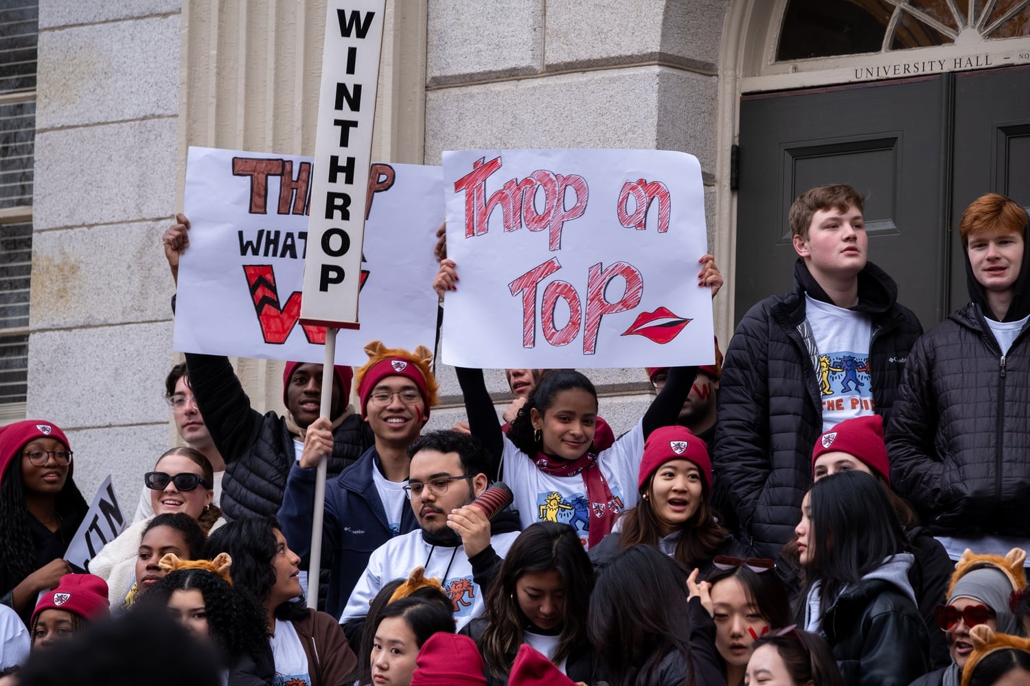 Winthrop students hold house-pride posters for Housing Day while standing on University Hall steps in March.
