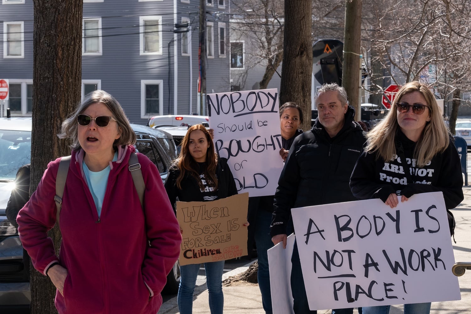 Members of the EMMA Coalition, a survivor-led advocacy group against sex trafficking, protested as 12 of the alleged clients of a high end brothel network were scheduled to make their first public appearance in court.