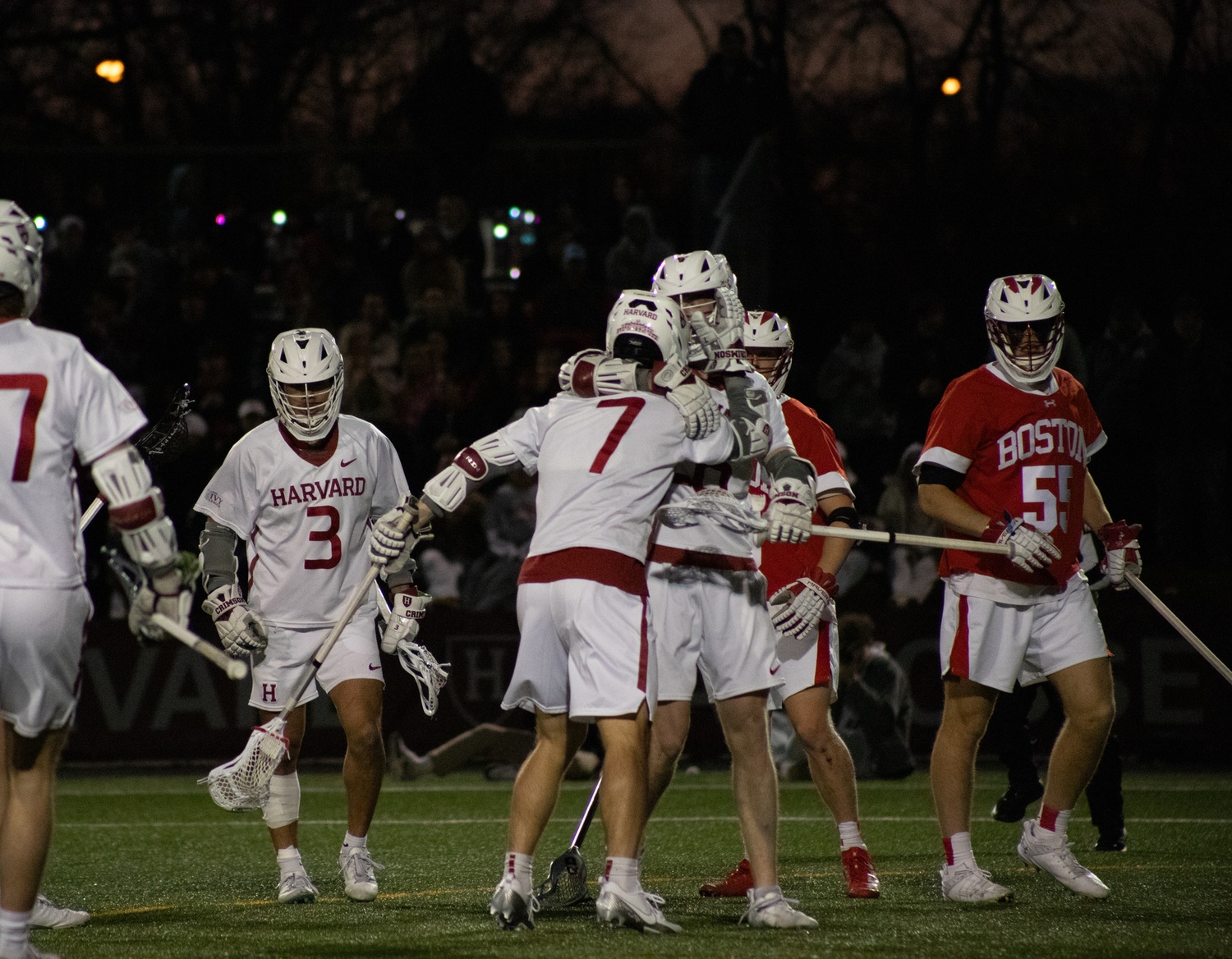 The team rejoices after scoring one of 16 goals against the Terriers in the cross-town rivalry matchup.
