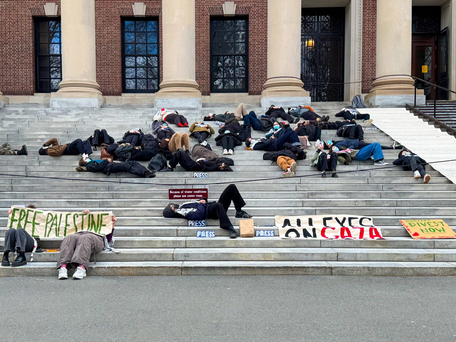 Students lie on the steps of Widener Library Thursday during a ‘die-in’ protest against the war in Gaza. The protest was organized by Harvard Out of Occupied Palestine.
