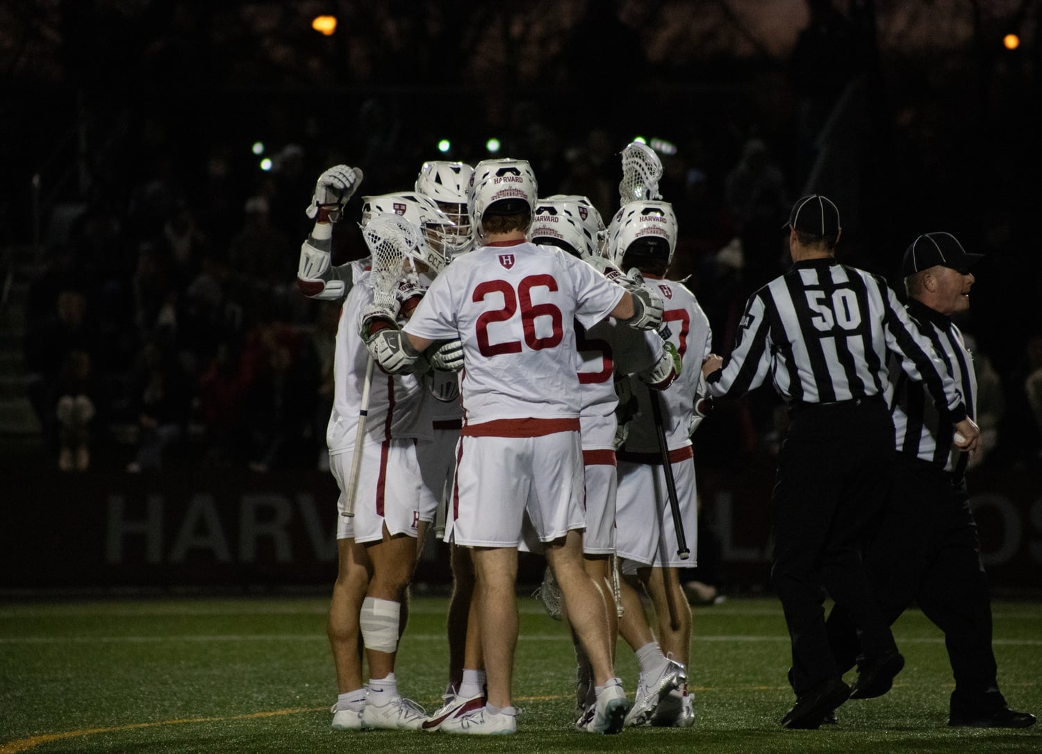 The men's lacrosse team huddles during a matchup against Boston University
