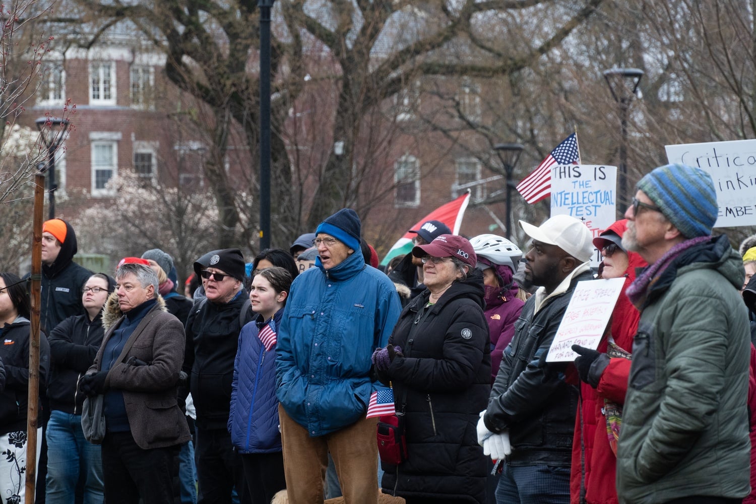 Protesters gather on Cambridge Common on Saturday to urge Harvard to stand up to President Donald Trump’s campaign against universities. Hundreds braved the rain to attend the rally, which was organized by the Cambridge City Council and the Harvard chapter of the American Association of University Professors.